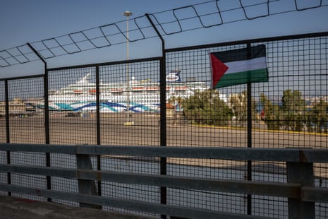A Palestinian flag hung by demonstrators on a fence of the Port of Piraeus.