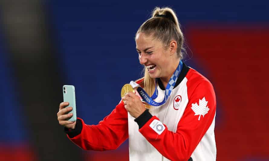 Janine Beckie celebrates with her Olympic gold medal in Japan in August.