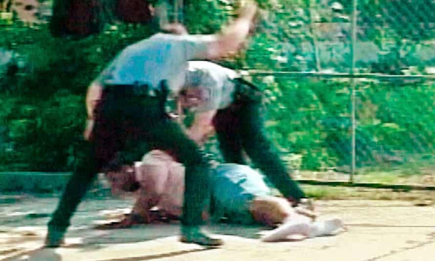 Two white Oklahoma City officers subdue a black suspect in 2002. Both officers faced a disciplinary investigation.