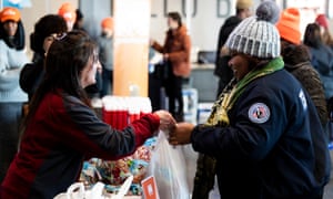 TSA worker Amelia Williams, right, is collecting food at a donation site created by the New York Food Bank in New York.