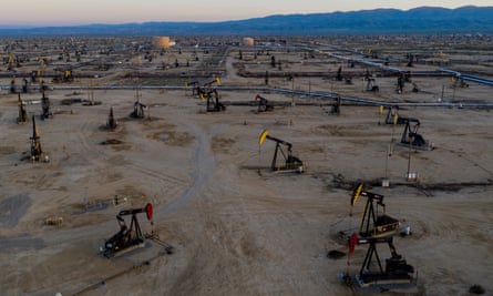Oil pumpjacks in a desert landscape.
