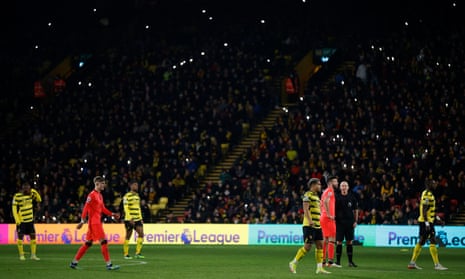 Players from both teams during a partial floodlight failure.