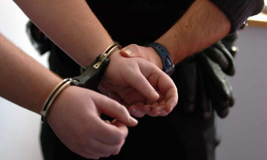 A prisoner in handcuffs.