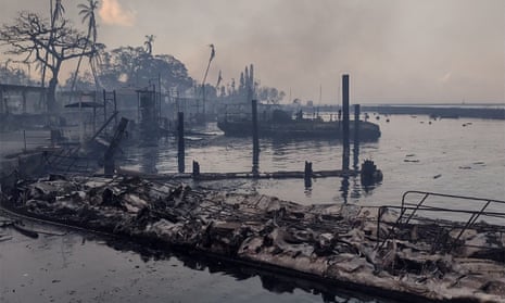 A charred boat lies on the scorched waterfront after a wildfire devastated the Maui city of Lahaina, 9 August 2023.