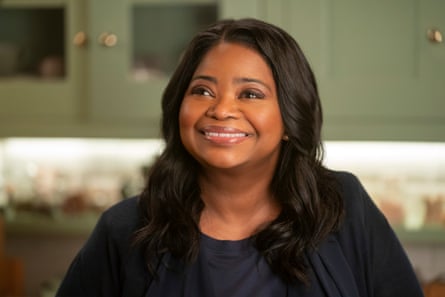 A woman of colour with dark shoulder-length hair, wearing black and smiling