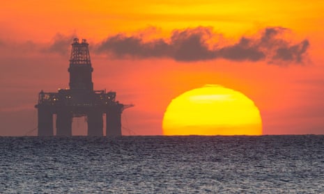 The sun rises by a redundant oil platform moored of Kirkcaldy in the North Sea