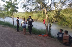 Tania Vanessa Ávalos of El Salvador, center left, is assisted by Mexican authorities after her husband and nearly two-year-old daughter were swept away by the current while trying to cross the Rio Grande to Brownsville, Texas, in Matamoros, Mexico.