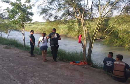 Tania Vanessa Ávalos of El Salvador, center left, is assisted by Mexican authorities after her husband and nearly two-year-old daughter were swept away by the current while trying to cross the Rio Grande to Brownsville, Texas, in Matamoros, Mexico.