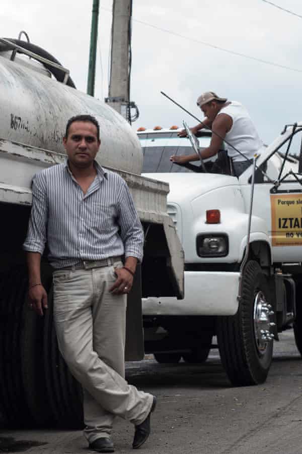 Adrian Vasquez with his water delivery truck. Vazquez lives in the community he serves and knows the tensions around water provision only too well.