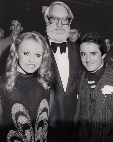 A black and white photo of David Stratton with Jacki Weaver and a man