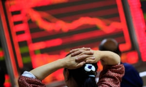 An investor looks at an electronic screen showing stock market movements at a securities brokerage house in Beijing, China, 24 June 2016.