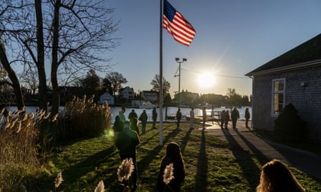 Voters line up to cast their ballots in the midterm election at the Aspray Boat House in Warwick, Rhode Island, on 8 November.