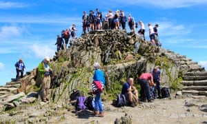 Walkers crowd on to the summit point, Snowdon