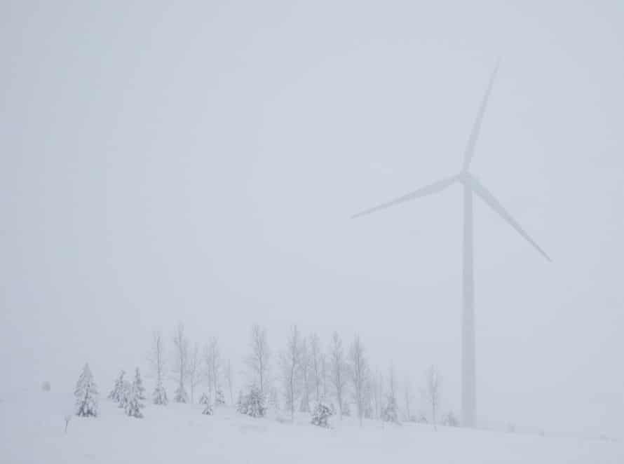 A wind turbine among snow covered trees near Beaver Dam, Wisconsin.