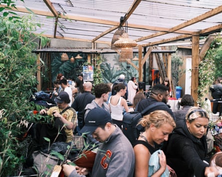 People shop in a jumble sale.
