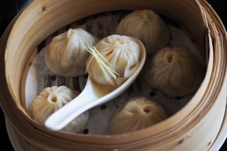 Dumplings in a dish, one resting on a white spoon