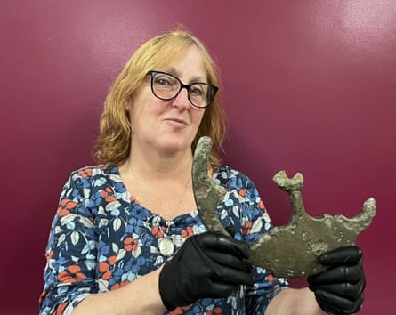 Lydia Bassett holding the remains of an astrolabe.