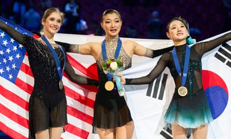 Gold medalist Kaori Sakamoto of Japan, center, poses with silver medalist Isabeau Levito of the United States, left, and bronze medalist Kim Chae-yeon of South Korea during Friday’s victory ceremony at figure skating worlds.
