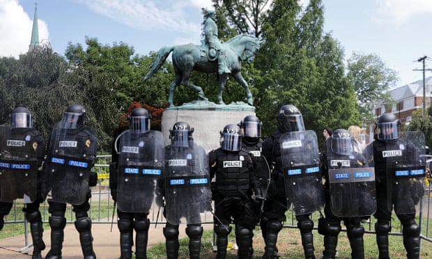 Police stand in front of the Charlottesville statue of Robert E Lee in August 2017.