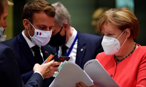 Germany’s Angela Merkel and Emmanuel Macron in masks, talking