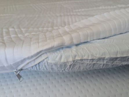 Origin Mattress Topper, partially unzipped to show interior construction.