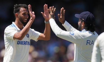Prasidh Krishna (left) celebrates one of this three wickets with KL Rahul as India restricted Australia 181 in their first innings on day two of the fifth Test at the SCG.