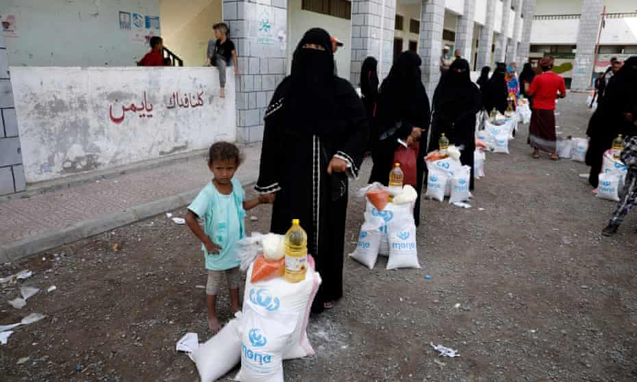 Yemeni women and children collecting their food rations