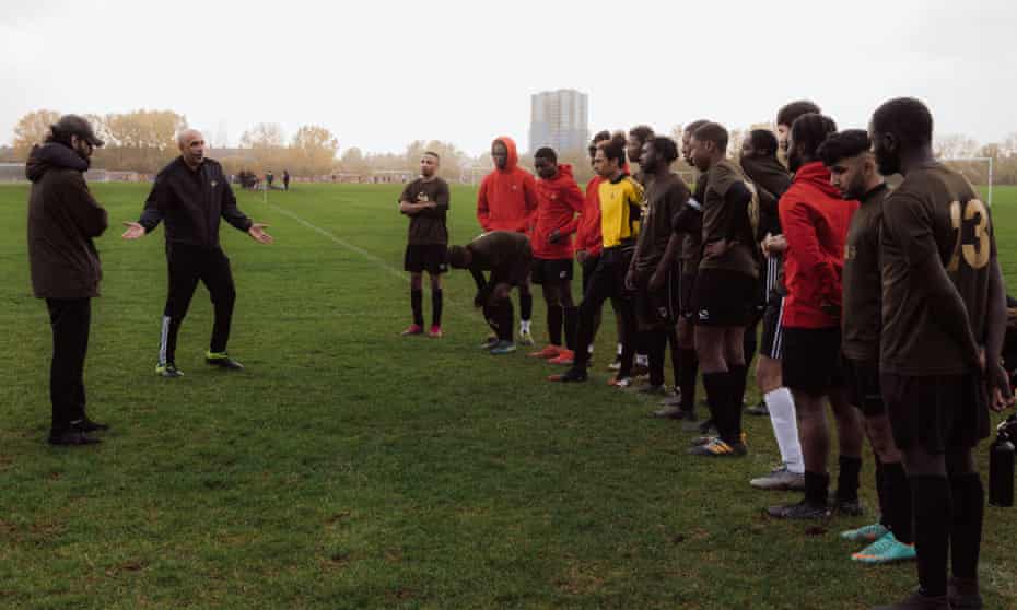 SP United team members line up for a pep talk from Sabir Bham