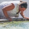 A woman after dunking her head in a fountain.