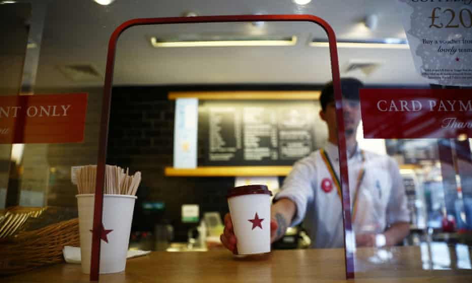 A coffee is passed to a customer at Pret a Manger in New Cavendish Street, London