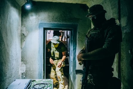 Two people with masks over their face in a bunker