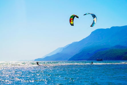 Two surfers enjoying kite surfing at the beach where Azmak River meets the Mediterranean Sea