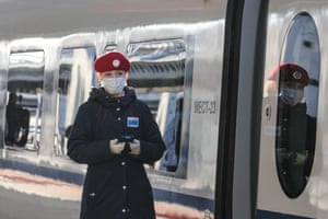 A Sapsan high-speed express train attendant stands on a platform at Moscow railway station