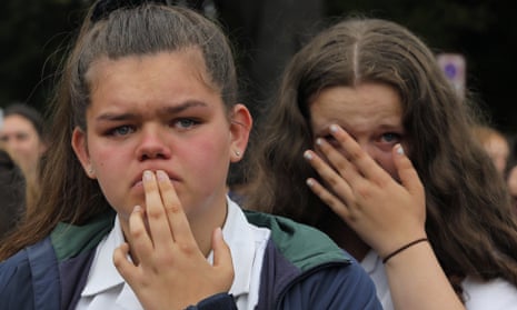 Students react as they gather for a vigil to commemorate victims of Friday’s shooting, outside the Al Noor mosque in Christchurch.