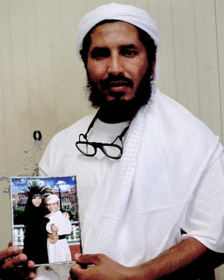 Ahmed al-Darbi, holding a photograph of his children, photographed inside Guantánamo.