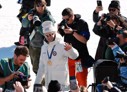 Johannes Høsflot Klæbo of Norway waves to the media after the cross-country skiing men’s 10km interval start free medal ceremony