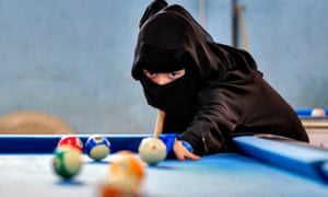 Sana’a, Yemen. A woman plays billiards during a local championship