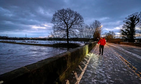 A council worker in Didsbury, Manchester, checks a bridge over the River Mersey for damage after heavy rainfall