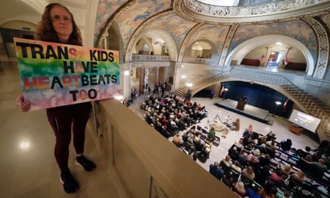 Campaigner Julia Williams holds a sign at the Missouri statehouse in Jefferson City in counterprotest during a rally in favor of a ban on gender-affirming health care legislation.