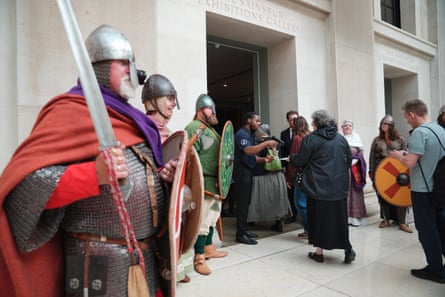 People in costume at entrance to Bayeux tapestry exhibition in London