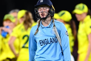 Charlie Dean of England leaves the field after being dismissed.