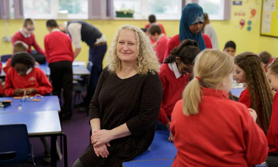 Headteacher Sue Vermes in a busy classroom at Rose Hill primary school in Oxford.