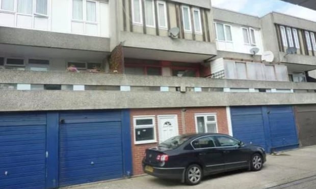 The converted one-bedroom garage with a car parked outside