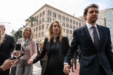 Elizabeth Holmes walks with her mother and partner before her sentencing hearing in San Jose last November.