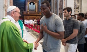 Pope Francis is greeted by a migrant at a mass to commemorate the fifth anniversary of his visit in Lampedusa.
