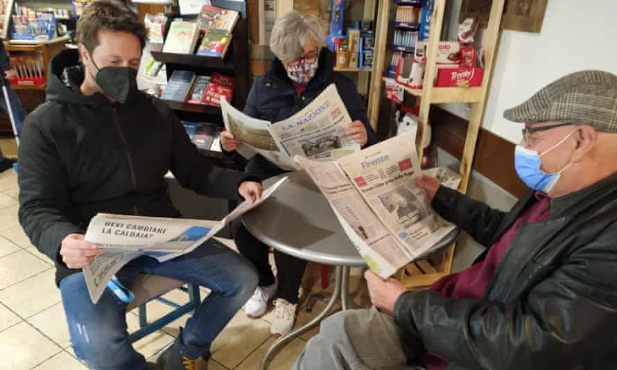 Daniela Suggelli reads a newspaper with two fellow residents of Galliano di Mugello.