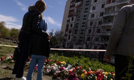 A woman and child pay tribute to victims of a Russian missile attack in Uman, where six children were killed on 28 April