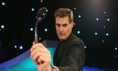 Illusionist and magician Uri Geller deforms a spoon for a TV show in 2008 in Cologne, Germany.  Photo by Ralf Juergens/Getty Images