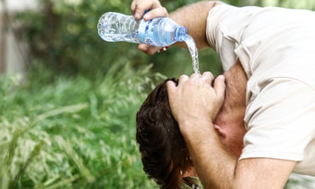 A man pours water on his head to cool off in Algiers this week during a heatwave.