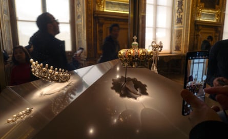 Museum goers inside the golden room which holds the French crown jewels in the Louvre